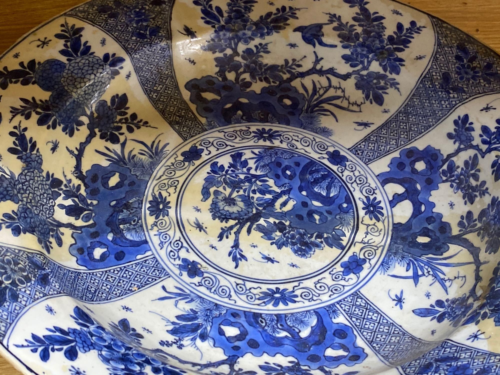 Four Chinese Kangxi period blue and white dishes and a Qianlong blue and white dish